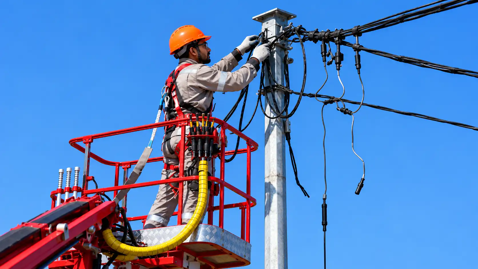 Electrician wearing a hard hat, working with PPE